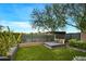 Landscaped backyard with daybed and artificial turf at 37200 N Cave Creek Rd # 1082, Scottsdale, AZ 85262
