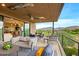 Covered patio with comfortable seating, mountain views, and golf course views at 37200 N Cave Creek Rd # 1082, Scottsdale, AZ 85262