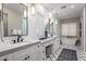 Elegant bathroom with double vanities, large soaking tub, and patterned floor at 37200 N Cave Creek Rd # 1082, Scottsdale, AZ 85262