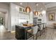Modern kitchen with white cabinetry, a large island, and high-end appliances at 37200 N Cave Creek Rd # 1082, Scottsdale, AZ 85262