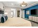 Main bedroom with blue accent wall, large TV, and ensuite bathroom view at 37200 N Cave Creek Rd # 1082, Scottsdale, AZ 85262