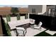 Modern patio design with sectional seating surrounding a fire pit, creating a cozy atmosphere at 9297 E Sundance Cir, Gold Canyon, AZ 85118