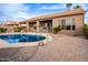 Home's backyard oasis features a sparkling pool and a paved patio at 568 N Falcon Dr, Gilbert, AZ 85234