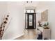 Bright and airy entryway with elegant chandelier and console table at 568 N Falcon Dr, Gilbert, AZ 85234