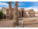 Eye-catching curb appeal with mature palm trees and rock garden at 568 N Falcon Dr, Gilbert, AZ 85234