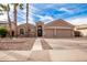 Two-story house with a three-car garage and desert landscaping at 568 N Falcon Dr, Gilbert, AZ 85234