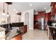 Spacious kitchen with dark wood cabinets, granite counters, and stainless steel appliances at 568 N Falcon Dr, Gilbert, AZ 85234