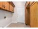 Laundry area with wooden cabinets and exterior access at 568 N Falcon Dr, Gilbert, AZ 85234