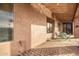 Covered patio with seating area and brick flooring at 568 N Falcon Dr, Gilbert, AZ 85234