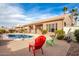 Relaxing pool area with patio chairs and backyard view at 568 N Falcon Dr, Gilbert, AZ 85234