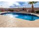 Inviting kidney-shaped pool with brick coping and a spacious patio at 568 N Falcon Dr, Gilbert, AZ 85234