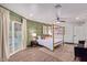 Main bedroom with a gold canopy bed and sliding glass doors leading to the pool at 6908 E Mariposa Dr, Scottsdale, AZ 85251