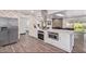 Modern kitchen featuring island, stainless steel appliances, and white cabinetry at 6908 E Mariposa Dr, Scottsdale, AZ 85251
