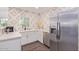 Modern kitchen with white cabinets and geometric backsplash at 6908 E Mariposa Dr, Scottsdale, AZ 85251
