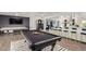 Game room with pool table, shuffleboard, and bar seating at 6908 E Mariposa Dr, Scottsdale, AZ 85251