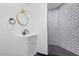 Modern bathroom with a hexagon-tiled shower and white vanity at 6908 E Mariposa Dr, Scottsdale, AZ 85251
