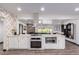 White kitchen with large island, stainless steel appliances, and patterned backsplash at 6908 E Mariposa Dr, Scottsdale, AZ 85251