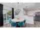 Bright dining room with round table, chandelier, and view to backyard at 6908 E Mariposa Dr, Scottsdale, AZ 85251
