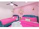 Two twin beds in a stylish bedroom with pink bedding and unique wallpaper at 6908 E Mariposa Dr, Scottsdale, AZ 85251