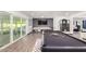 Game room with pool table, shuffleboard, and a large TV at 6908 E Mariposa Dr, Scottsdale, AZ 85251
