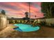 Stunning pool at twilight with colorful sky and landscape lighting at 6908 E Mariposa Dr, Scottsdale, AZ 85251