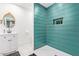 Spa-like bathroom featuring a teal tile shower and a white vanity at 6908 E Mariposa Dr, Scottsdale, AZ 85251