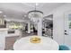 Bright dining room with chandelier and view into the living room and kitchen at 6908 E Mariposa Dr, Scottsdale, AZ 85251