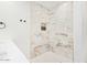 Elegant shower with marble tile and gold accents at 6908 E Mariposa Dr, Scottsdale, AZ 85251