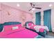 Two twin beds in a stylish bedroom with pink bedding and unique wallpaper at 6908 E Mariposa Dr, Scottsdale, AZ 85251