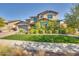 Two story home with landscaped yard and artificial turf at 2327 N Beverly Pl, Buckeye, AZ 85396