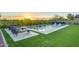 Inviting backyard oasis featuring a sparkling pool, artificial turf, and lounge chairs at 2327 N Beverly Pl, Buckeye, AZ 85396