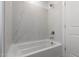 Clean bathroom with a bathtub and marble surround at 7499 E Sweet Honey Ln, San Tan Valley, AZ 85143