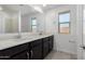 Modern bathroom with double vanity and a window at 7499 E Sweet Honey Ln, San Tan Valley, AZ 85143