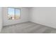 Well-lit bedroom featuring carpet and a window at 7499 E Sweet Honey Ln, San Tan Valley, AZ 85143