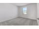 Bright bedroom with carpet flooring and a large window at 7499 E Sweet Honey Ln, San Tan Valley, AZ 85143