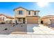 Two-story house with tan exterior, light green shutters, and a two-car garage at 7499 E Sweet Honey Ln, San Tan Valley, AZ 85143