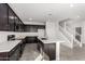 Modern kitchen with dark cabinetry and an island at 7499 E Sweet Honey Ln, San Tan Valley, AZ 85143