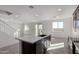 Open kitchen with island, stainless steel appliances, and view into living area at 7499 E Sweet Honey Ln, San Tan Valley, AZ 85143
