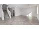 Spacious living room with grey tile floors and a staircase at 7499 E Sweet Honey Ln, San Tan Valley, AZ 85143