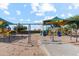 Community playground with shaded swings for children at 38100 W Excussare Way, Maricopa, AZ 85138