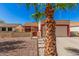 House exterior with a beige stucco finish, red accents, and a two-car garage at 10014 N 66Th Ln, Glendale, AZ 85302