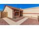 House exterior with a beige stucco finish, red accents, and a two-car garage at 10014 N 66Th Ln, Glendale, AZ 85302