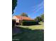 Large backyard with a covered patio and American flag at 272 Leisure World --, Mesa, AZ 85206