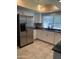 Bright kitchen featuring stainless steel refrigerator and white cabinets at 272 Leisure World --, Mesa, AZ 85206