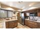 Kitchen with granite countertops, stainless steel appliances, and wood cabinets at 9220 E Whitethorn Cir, Scottsdale, AZ 85266