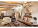 Spacious living room with hardwood floors, comfortable furniture, and a view of the dining area at 9220 E Whitethorn Cir, Scottsdale, AZ 85266