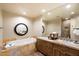 Elegant bathroom with double vanity, soaking tub, and walk-in shower at 9220 E Whitethorn Cir, Scottsdale, AZ 85266