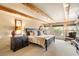 Main bedroom with large bed, dark wood furniture, and views of the backyard at 9220 E Whitethorn Cir, Scottsdale, AZ 85266