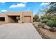 Tan stucco home with attached garage and desert landscaping at 9220 E Whitethorn Cir, Scottsdale, AZ 85266
