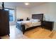 Spacious bedroom with light hardwood floors and a large bed at 2025 E Campbell Ave # 330, Phoenix, AZ 85016